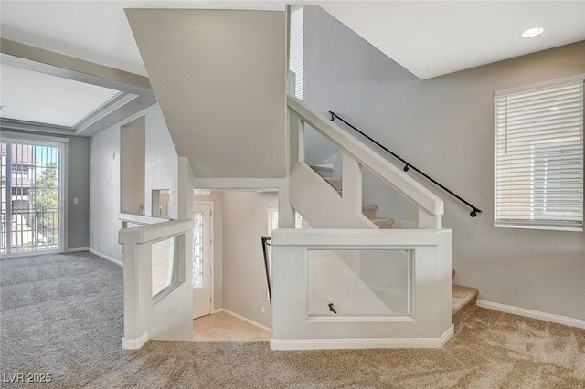 staircase featuring carpet floors and baseboards