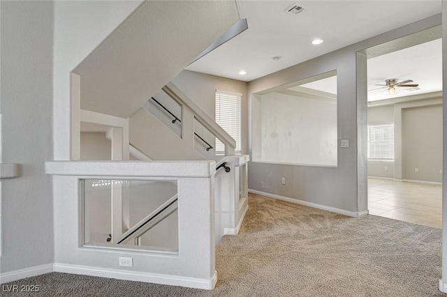 interior space with carpet flooring, visible vents, baseboards, and stairs