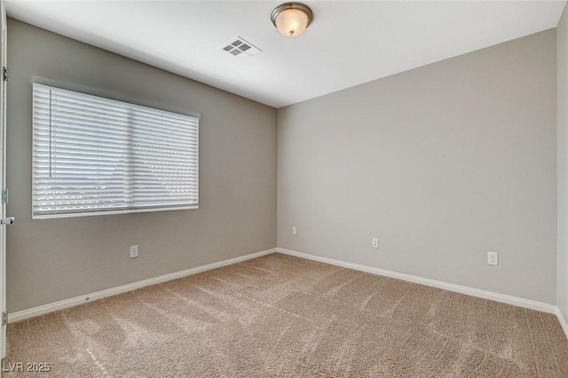 carpeted spare room with baseboards and visible vents