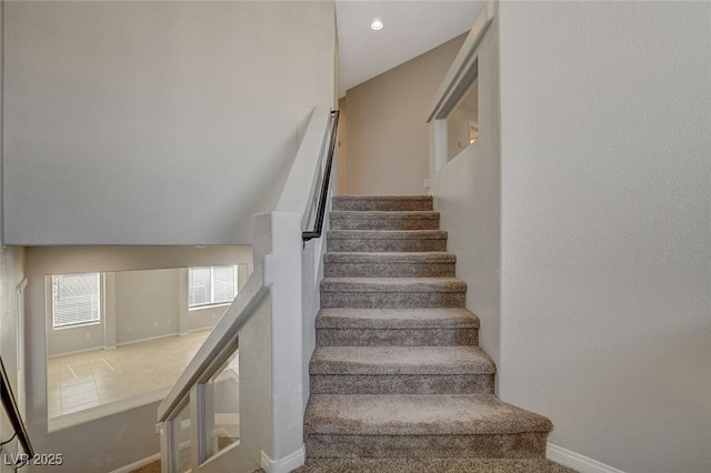 staircase featuring baseboards and recessed lighting