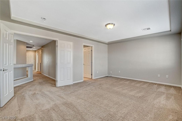 unfurnished bedroom featuring carpet floors, visible vents, and baseboards