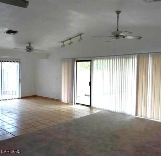 unfurnished room with rail lighting, tile patterned flooring, visible vents, and ceiling fan