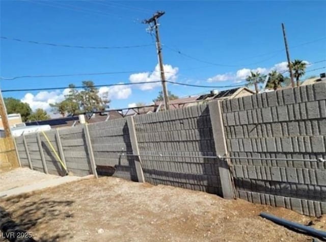 view of gate with a fenced backyard