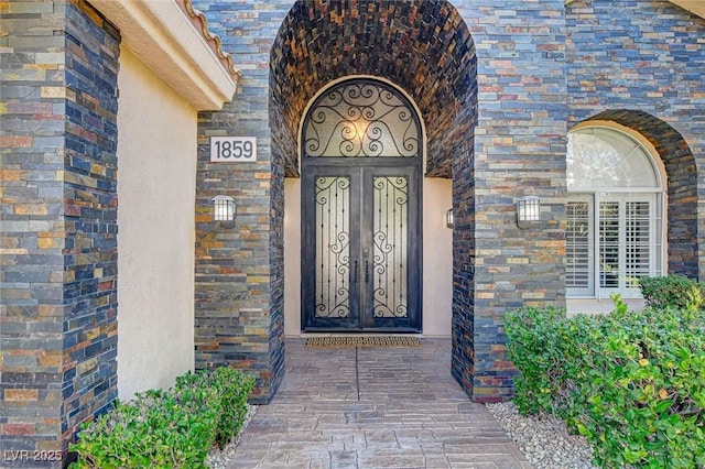 doorway to property featuring brick siding