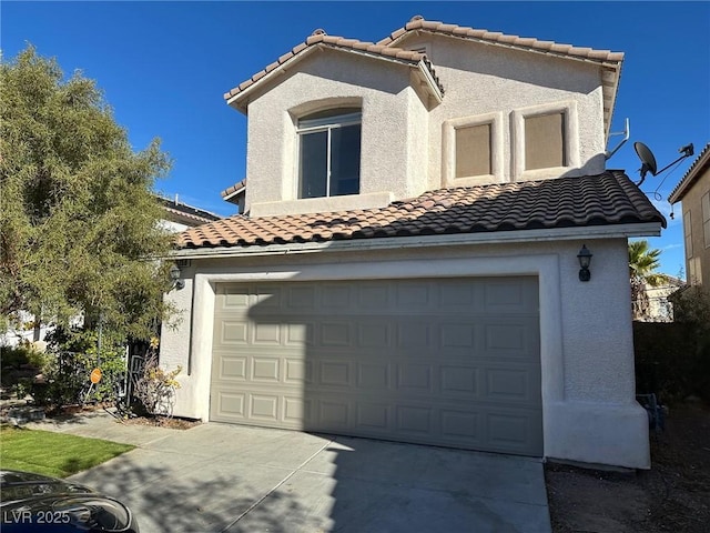 view of front of property featuring concrete driveway, an attached garage, and stucco siding