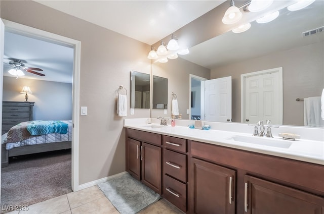 ensuite bathroom featuring ceiling fan, a sink, visible vents, and tile patterned floors