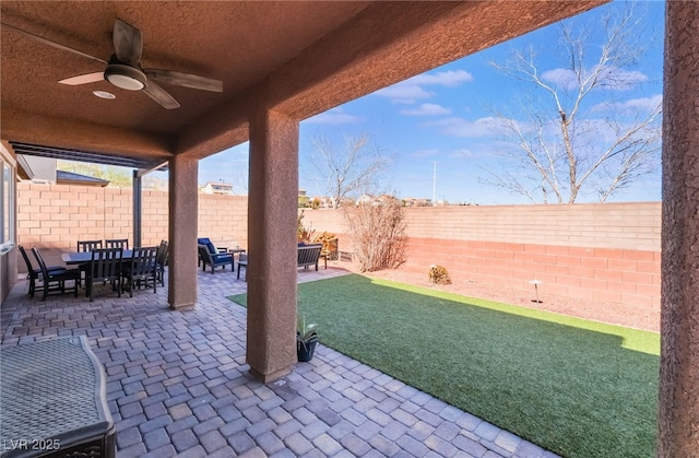 view of patio / terrace with a ceiling fan, outdoor dining area, and a fenced backyard