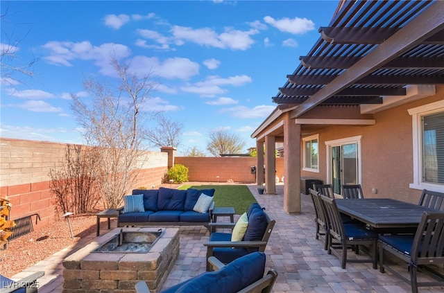 view of patio featuring a fenced backyard, outdoor dining area, a pergola, and an outdoor living space with a fire pit