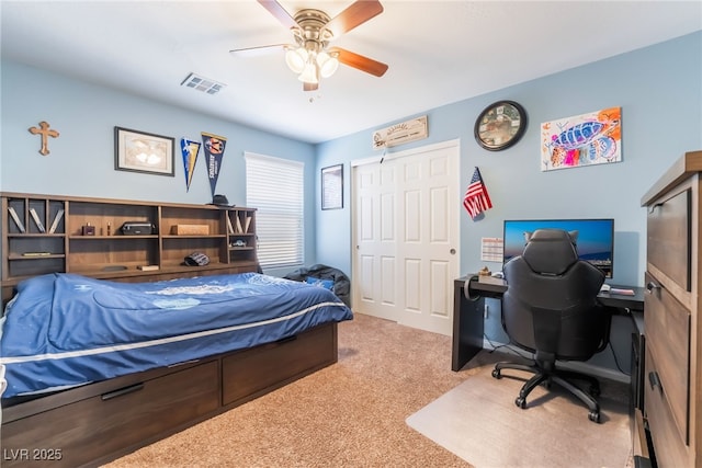 bedroom featuring a ceiling fan, visible vents, and carpet flooring