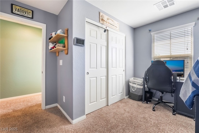 carpeted office with visible vents and baseboards