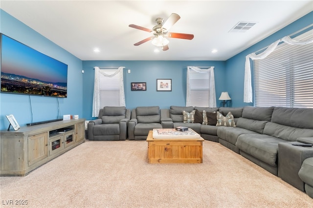 carpeted living room with visible vents, a ceiling fan, and recessed lighting