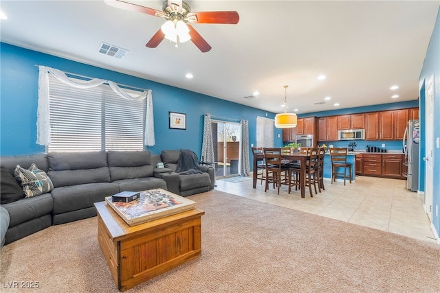 living room with light colored carpet, visible vents, recessed lighting, and light tile patterned floors