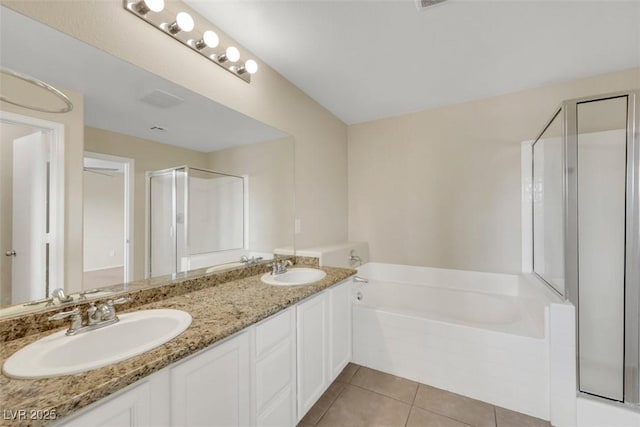 full bath with a garden tub, a stall shower, a sink, and tile patterned floors