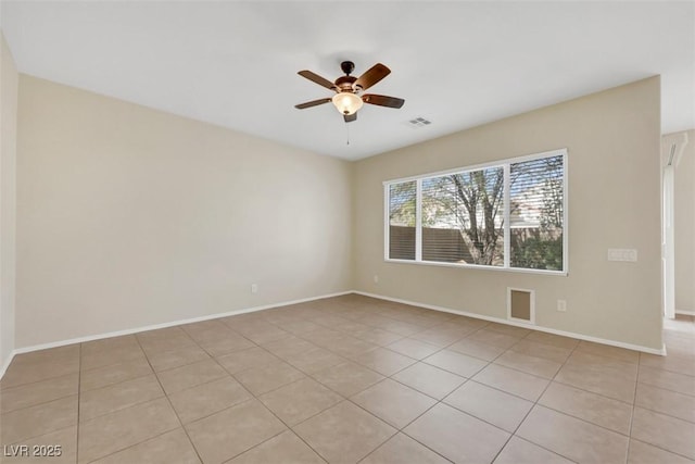 empty room featuring light tile patterned floors, ceiling fan, visible vents, and baseboards