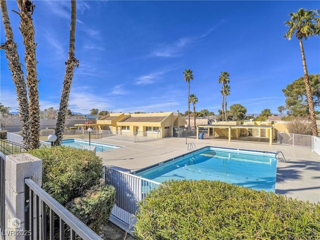 pool featuring a patio area and fence