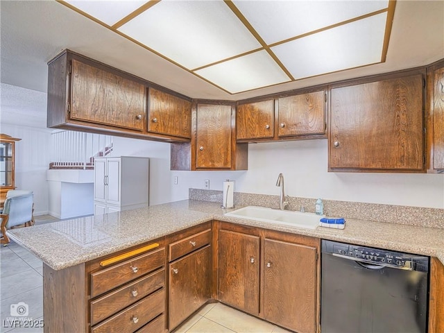 kitchen with black dishwasher, light tile patterned floors, light countertops, a sink, and a peninsula