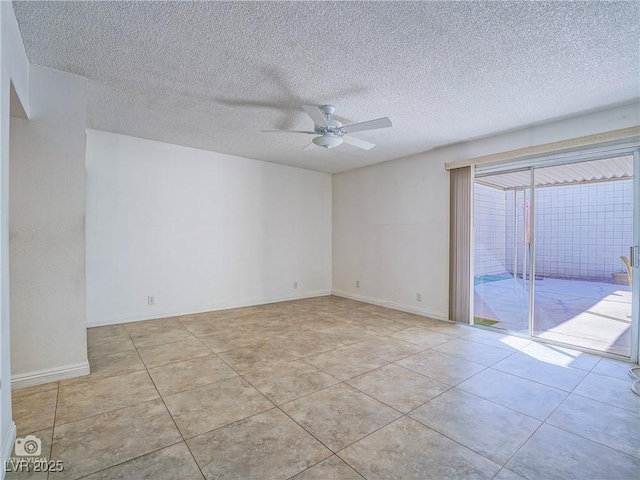 unfurnished room with tile patterned flooring, a ceiling fan, and baseboards