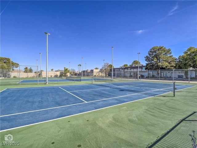 view of tennis court with fence