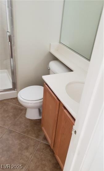 full bath featuring toilet, tile patterned floors, a shower stall, and vanity