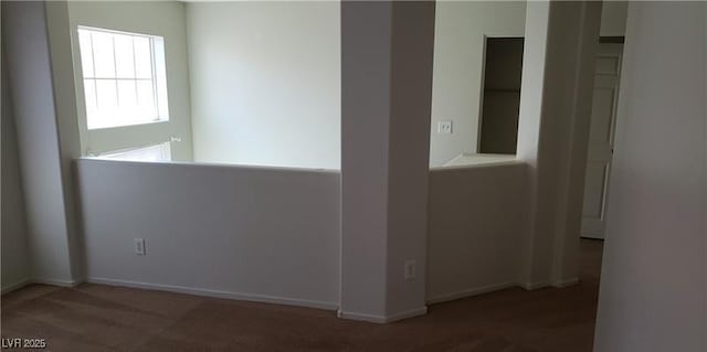 carpeted spare room featuring baseboards