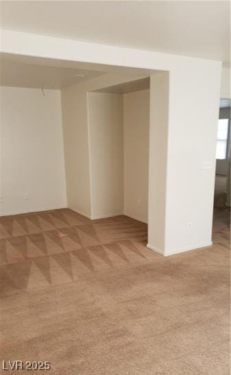 unfurnished room with light carpet