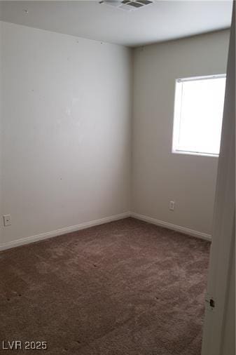 unfurnished room featuring carpet floors and baseboards