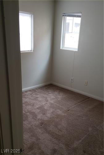 unfurnished room with carpet floors and baseboards