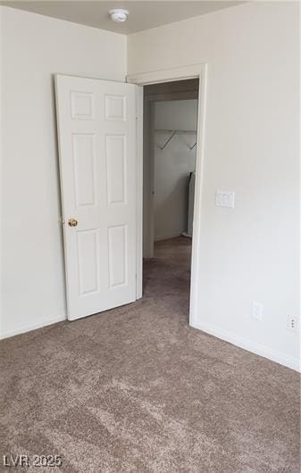 unfurnished bedroom featuring a closet, carpet flooring, and baseboards