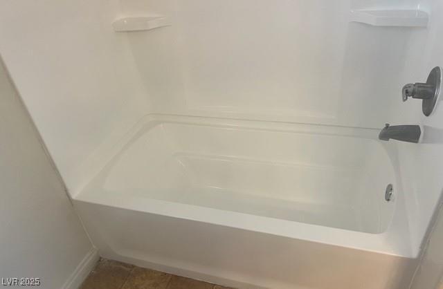 bathroom featuring shower / washtub combination and tile patterned floors