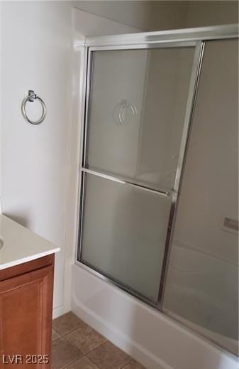 bathroom with tile patterned floors, combined bath / shower with glass door, and vanity