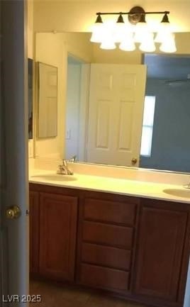 full bathroom with double vanity and a sink