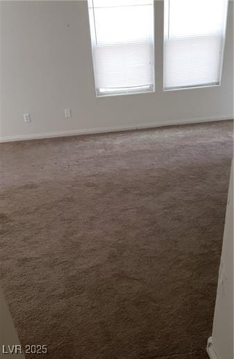 carpeted spare room with baseboards