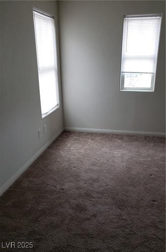 empty room featuring carpet floors and baseboards