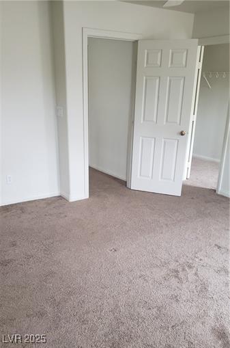 unfurnished bedroom featuring a closet and carpet