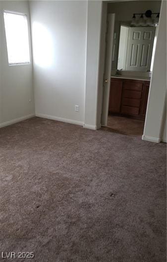 carpeted empty room with baseboards