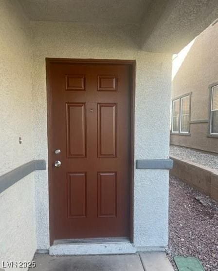 entrance to property with stucco siding