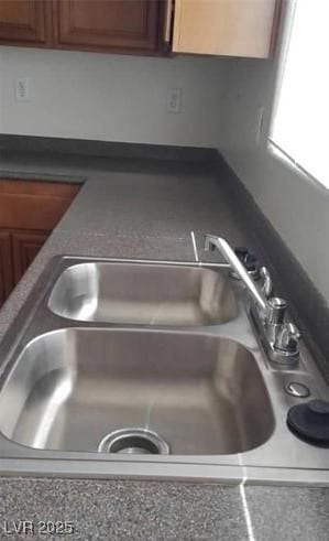 interior details with dark countertops and a sink