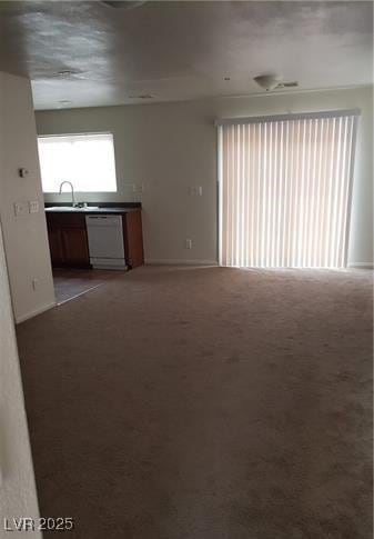 interior space featuring light carpet and a sink