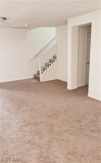 basement featuring stairs and carpet floors