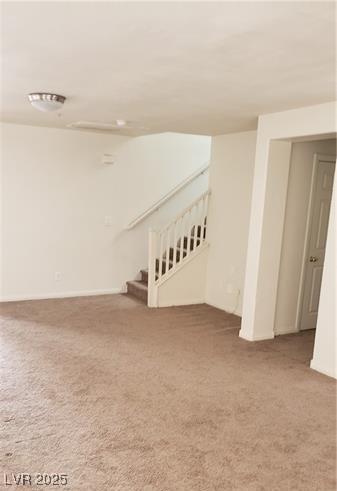 basement with carpet floors and stairs