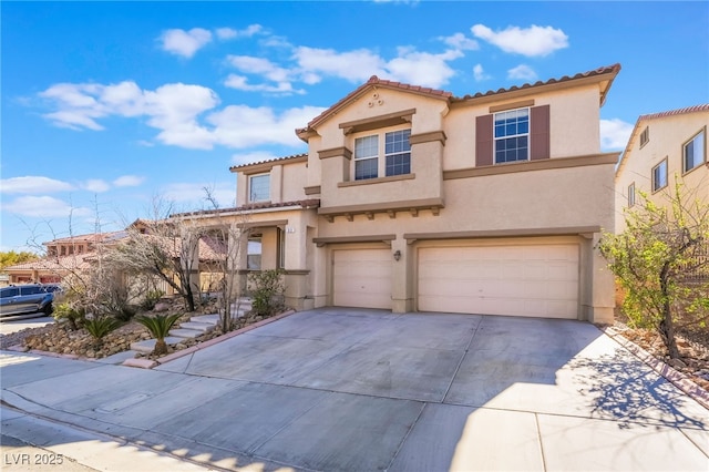 mediterranean / spanish house featuring concrete driveway, a tile roof, an attached garage, and stucco siding