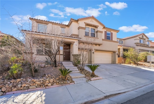 mediterranean / spanish house featuring a garage, concrete driveway, a tiled roof, and stucco siding