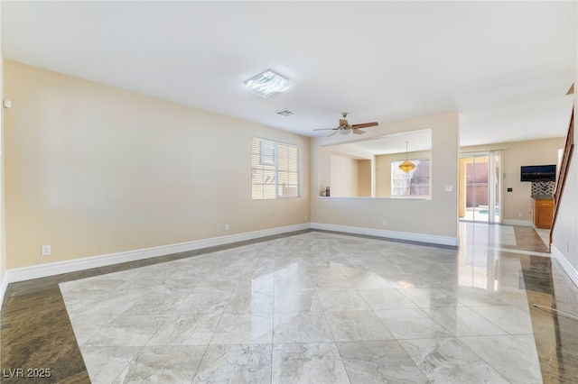 unfurnished room featuring marble finish floor, visible vents, ceiling fan, and baseboards