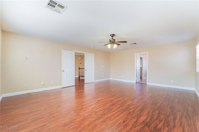 unfurnished room featuring baseboards, visible vents, and light wood finished floors