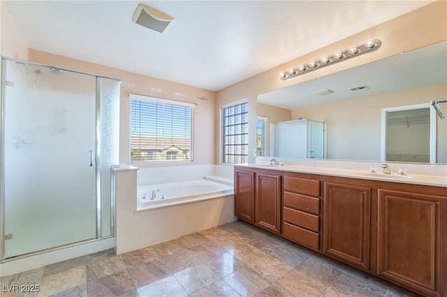 bathroom featuring double vanity, visible vents, a garden tub, a shower stall, and a sink