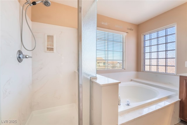 full bathroom with a garden tub and a marble finish shower