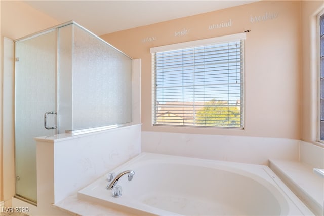 full bath featuring a stall shower and a garden tub