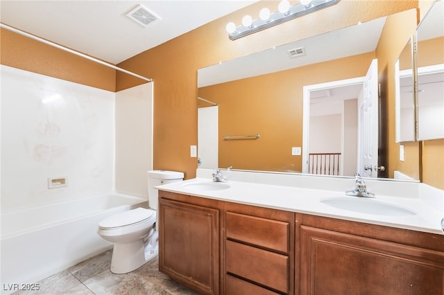 bathroom featuring toilet, visible vents, and a sink