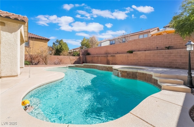 view of pool with a patio area, a fenced backyard, and a pool with connected hot tub