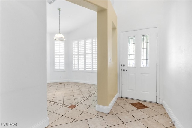 foyer with baseboards, a wealth of natural light, and light tile patterned flooring